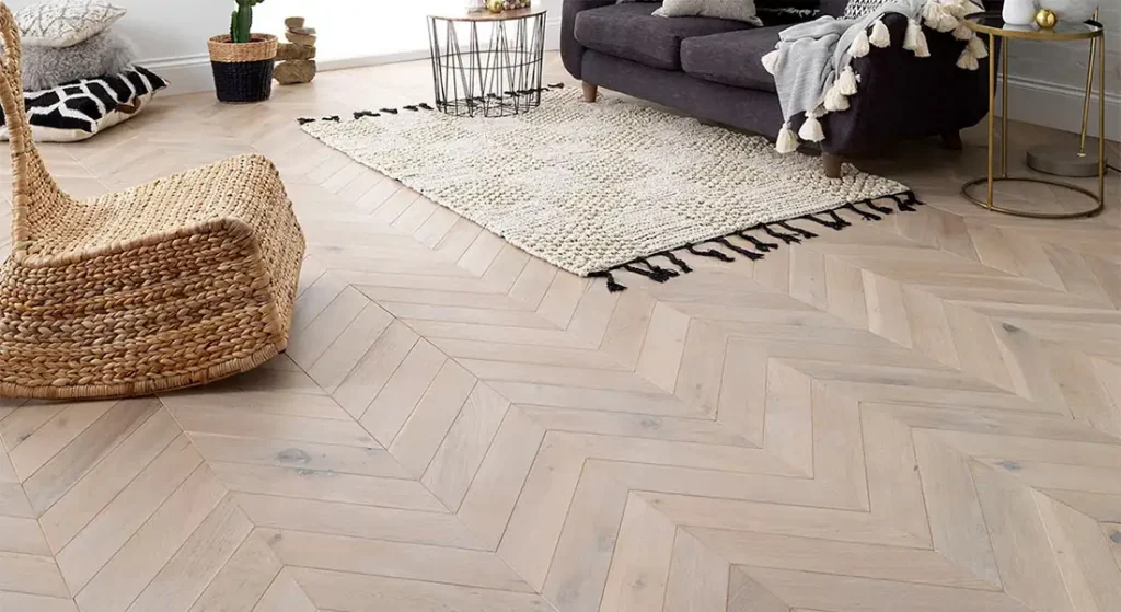 A light-colored wood floor with a chevroon pattern