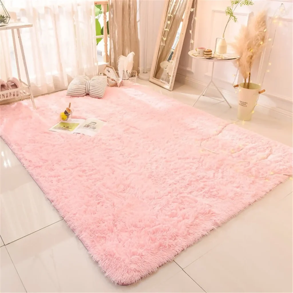 A large, fluffy pink rug is laid out on a white tiled floor in a bedroom.